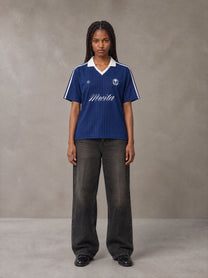 Model wearing the SM Legacy Jersey Polo T-shirt in Oxford Navy, front view.