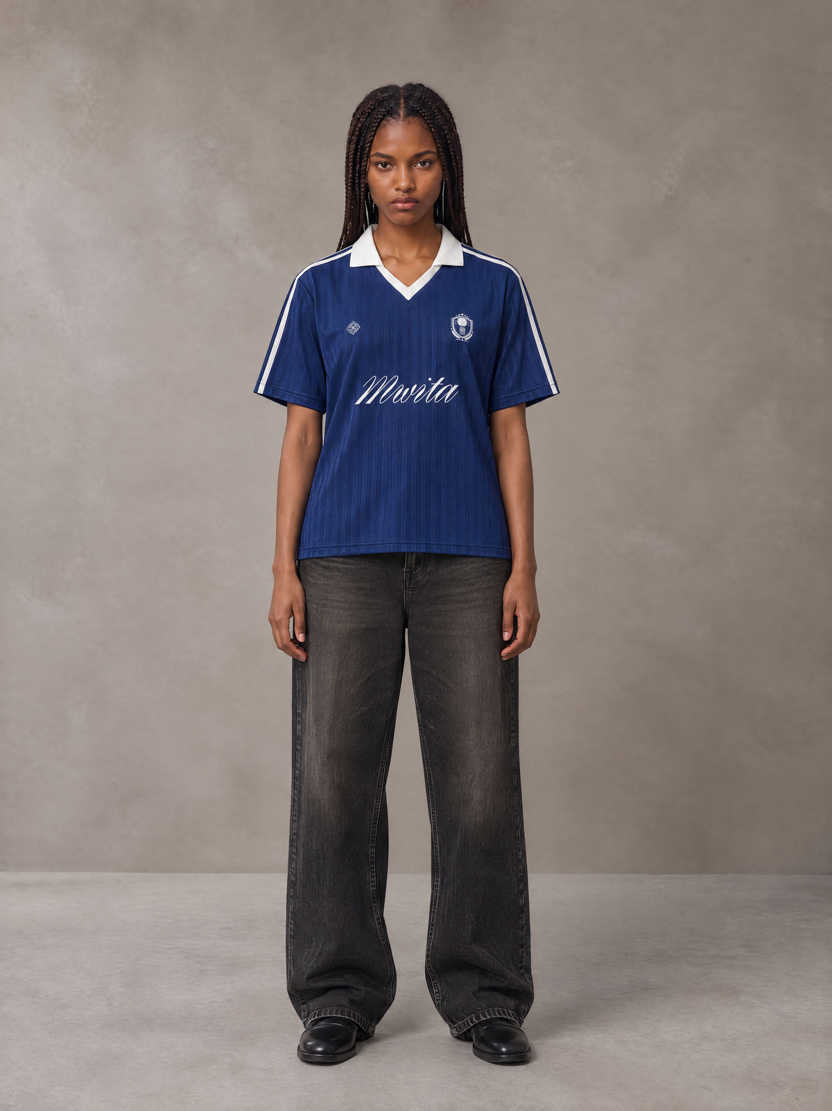 Model wearing the SM Legacy Jersey Polo T-shirt in Oxford Navy, front view.
