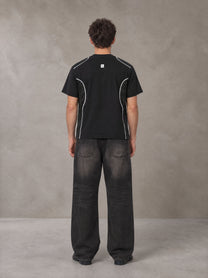 Model wearing the SM Legacy Jersey T-shirt in Midnight Black, rear view.