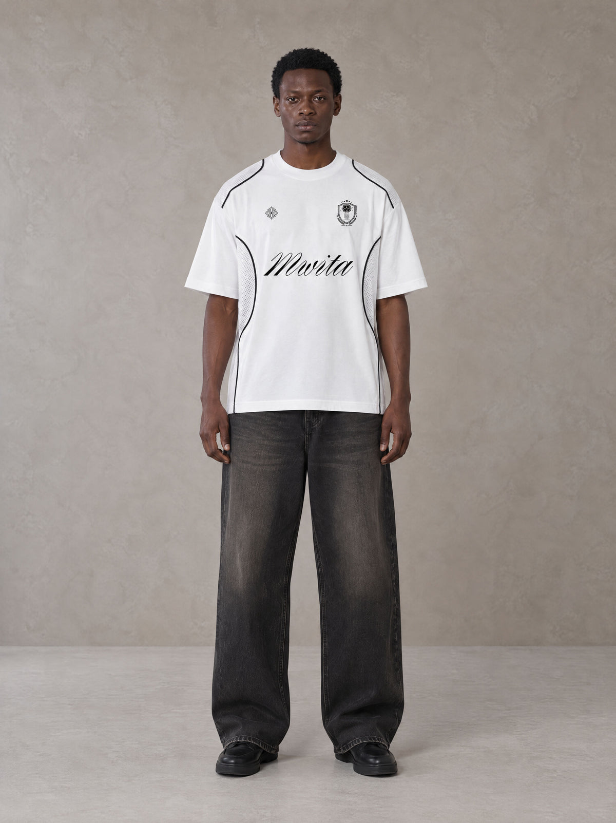 Model wearing the SM Legacy Jersey T-shirt in Lucent White, front view.