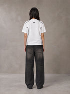 Model wearing the SM Legacy Jersey T-shirt in Lucent White, rear view.