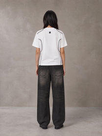 Model wearing the SM Legacy Jersey T-shirt in Lucent White, rear view.