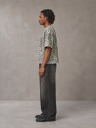 Model wearing the SM Leopard Print Boxy T-shirt in Cement, side profile.