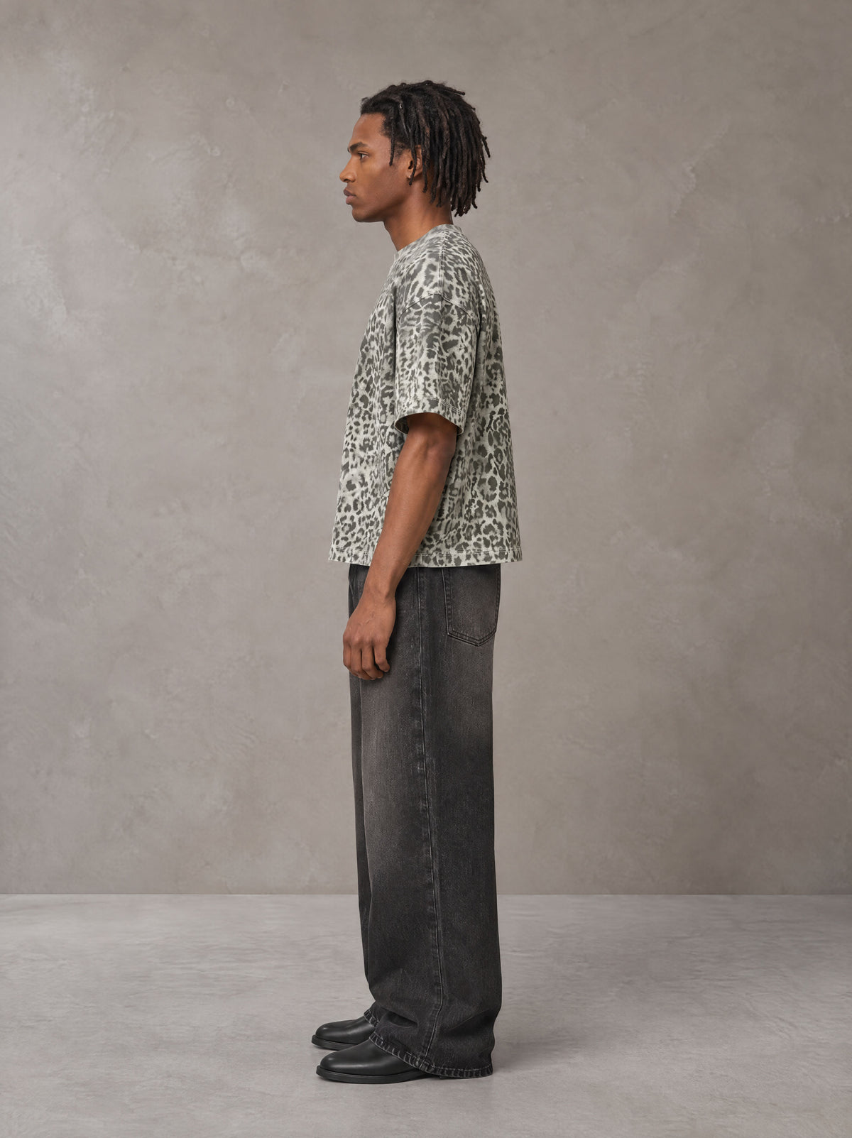 Model wearing the SM Leopard Print Boxy T-shirt in Cement, side profile.