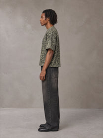 Model wearing the SM Leopard Print Boxy T-shirt in Granite Green, side profile.