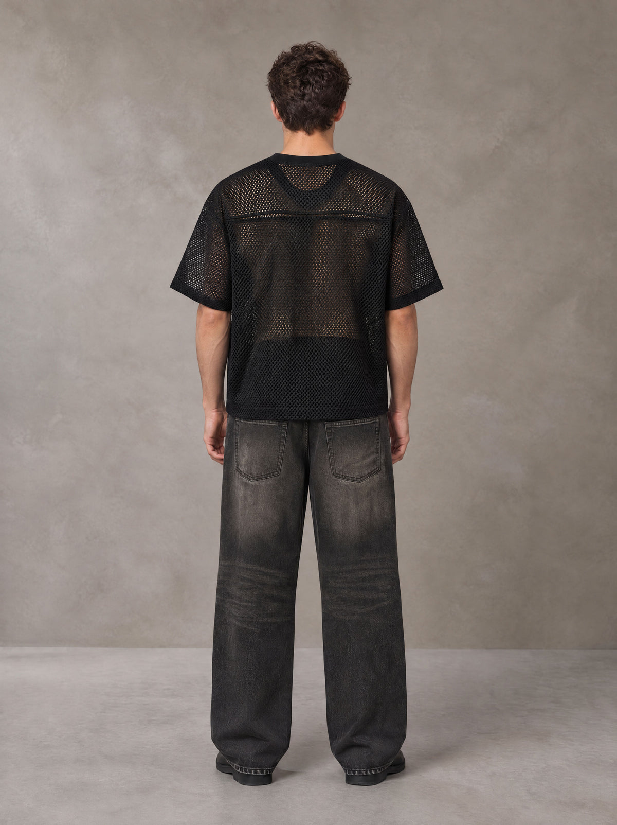 Model wearing the SM Mesh Boxy T-shirt in Midnight Black, rear view.