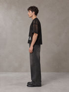 Model wearing the SM Mesh Boxy T-shirt in Midnight Black, side profile.