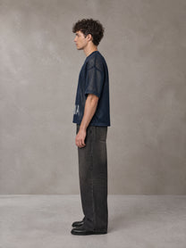 Model wearing the SM Mesh Boxy T-shirt in Oxford Navy, side profile.