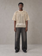 Model wearing the SM Mesh Boxy T-shirt in Soft Beige, front view.