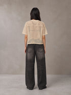 Model wearing the SM Mesh Boxy T-shirt in Soft Beige, rear view.