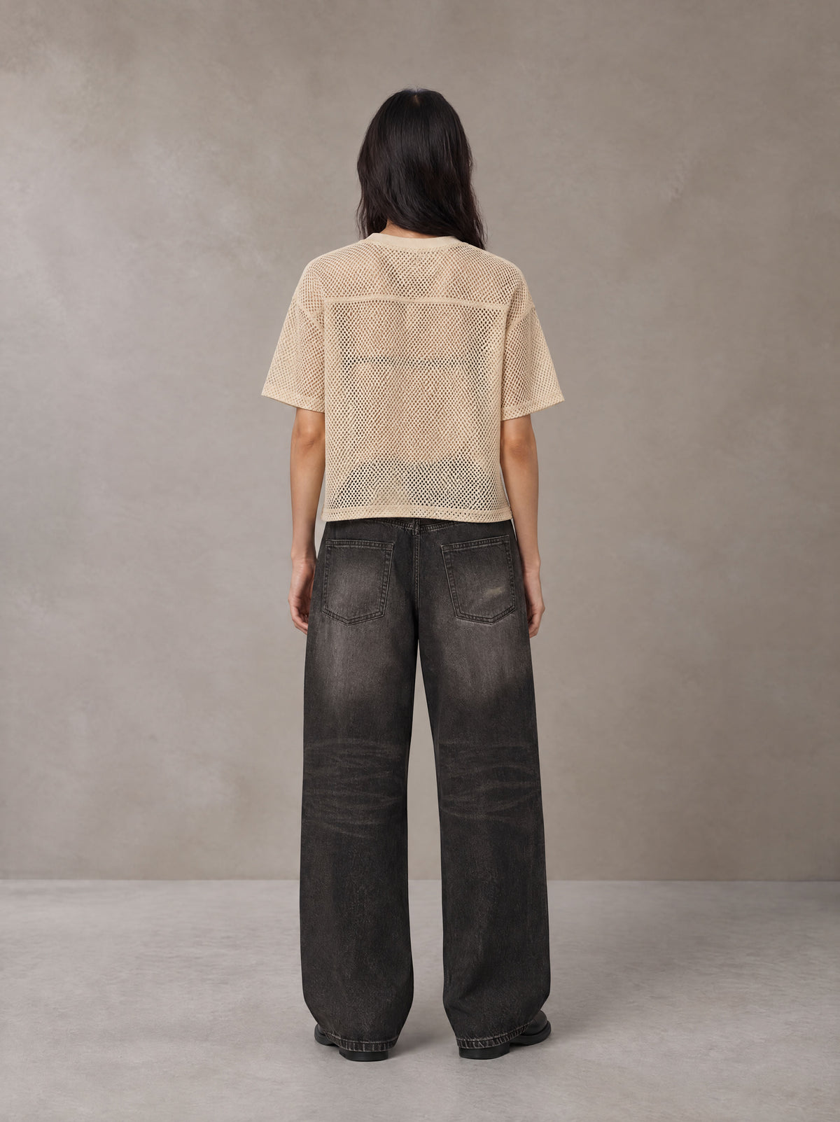 Model wearing the SM Mesh Boxy T-shirt in Soft Beige, rear view.