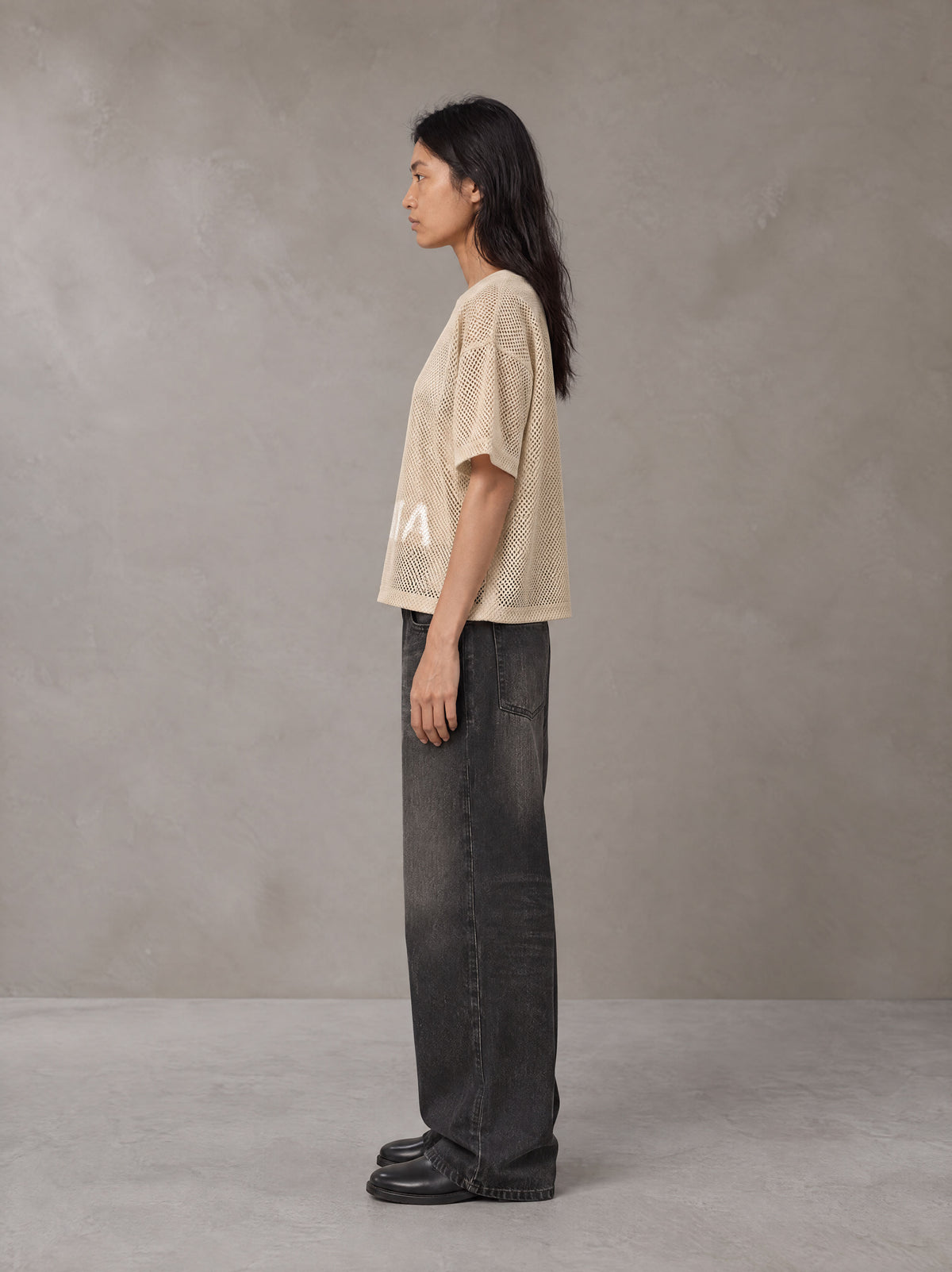 Model wearing the SM Mesh Boxy T-shirt in Soft Beige, side profile.