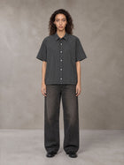 Model wearing the SM Pinstripe Short Sleeve Shirt in Deep Charcoal, front view.
