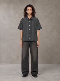Model wearing the SM Pinstripe Short Sleeve Shirt in Deep Charcoal, front view.
