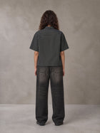 Model wearing the SM Pinstripe Short Sleeve Shirt in Deep Charcoal, rear view.