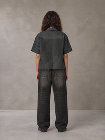 Model wearing the SM Pinstripe Short Sleeve Shirt in Deep Charcoal, rear view.