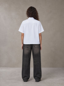 Model wearing the SM Pinstripe Short Sleeve Shirt in Lucent White, rear view.