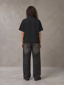 Model wearing the SM Pinstripe Short Sleeve Shirt in Midnight Black, rear view.