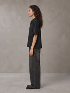 Model wearing the SM Pinstripe Short Sleeve Shirt in Midnight Black, side profile.