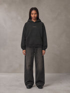 Model wearing the SM Regal Hoodie in Midnight Black, front view.
