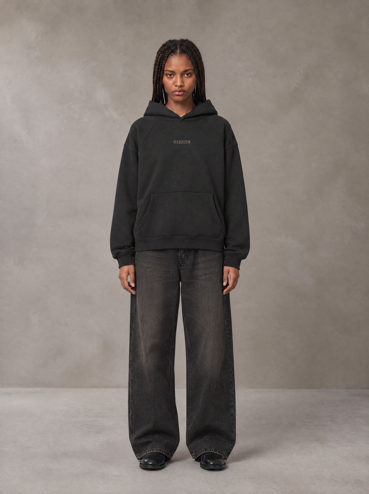 Model wearing the SM Regal Hoodie in Midnight Black, front view.