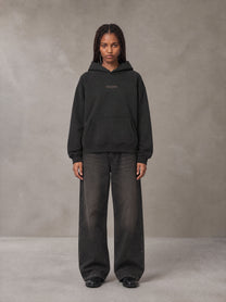 Model wearing the SM Regal Hoodie in Midnight Black, front view.