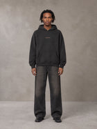 Model wearing the SM Regal Hoodie in Midnight Black, front view.