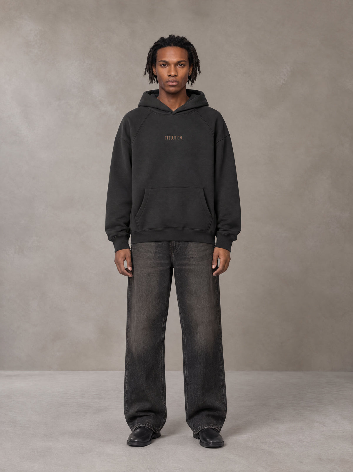 Model wearing the SM Regal Hoodie in Midnight Black, front view.