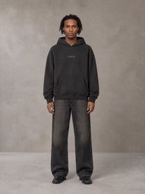 Model wearing the SM Regal Hoodie in Midnight Black, front view.