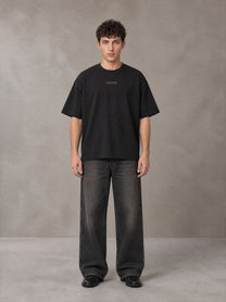Model wearing the SM Regal T-shirt in Midnight Black, front view.