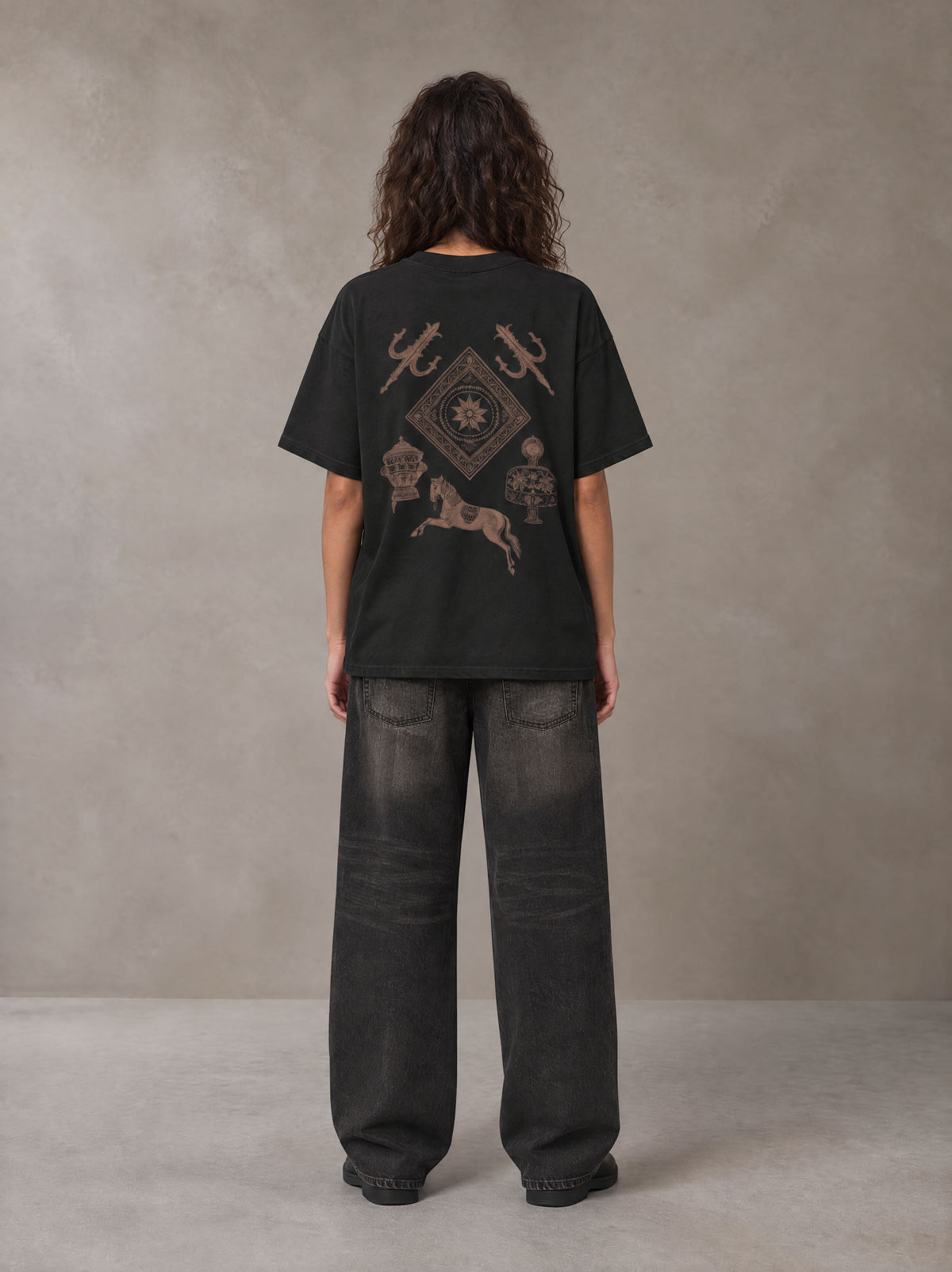 Model wearing the SM Regal T-shirt in Midnight Black, rear view.