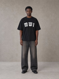 Model wearing the SM Script T-shirt in Midnight Black, front view.