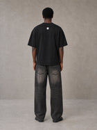 Model wearing the SM Script T-shirt in Midnight Black, rear view.