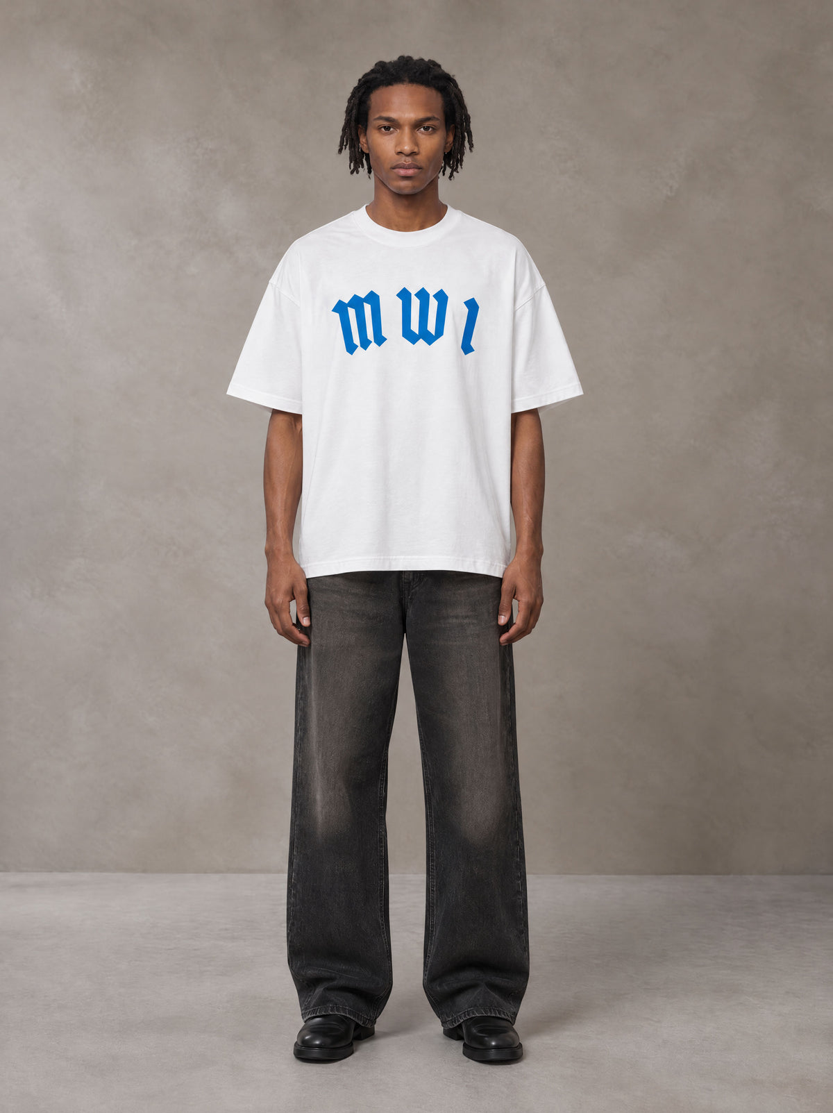 Model wearing the SM Script T-shirt in Lucent White, front view.