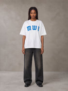 Model wearing the SM Script T-shirt in Lucent White, front view.