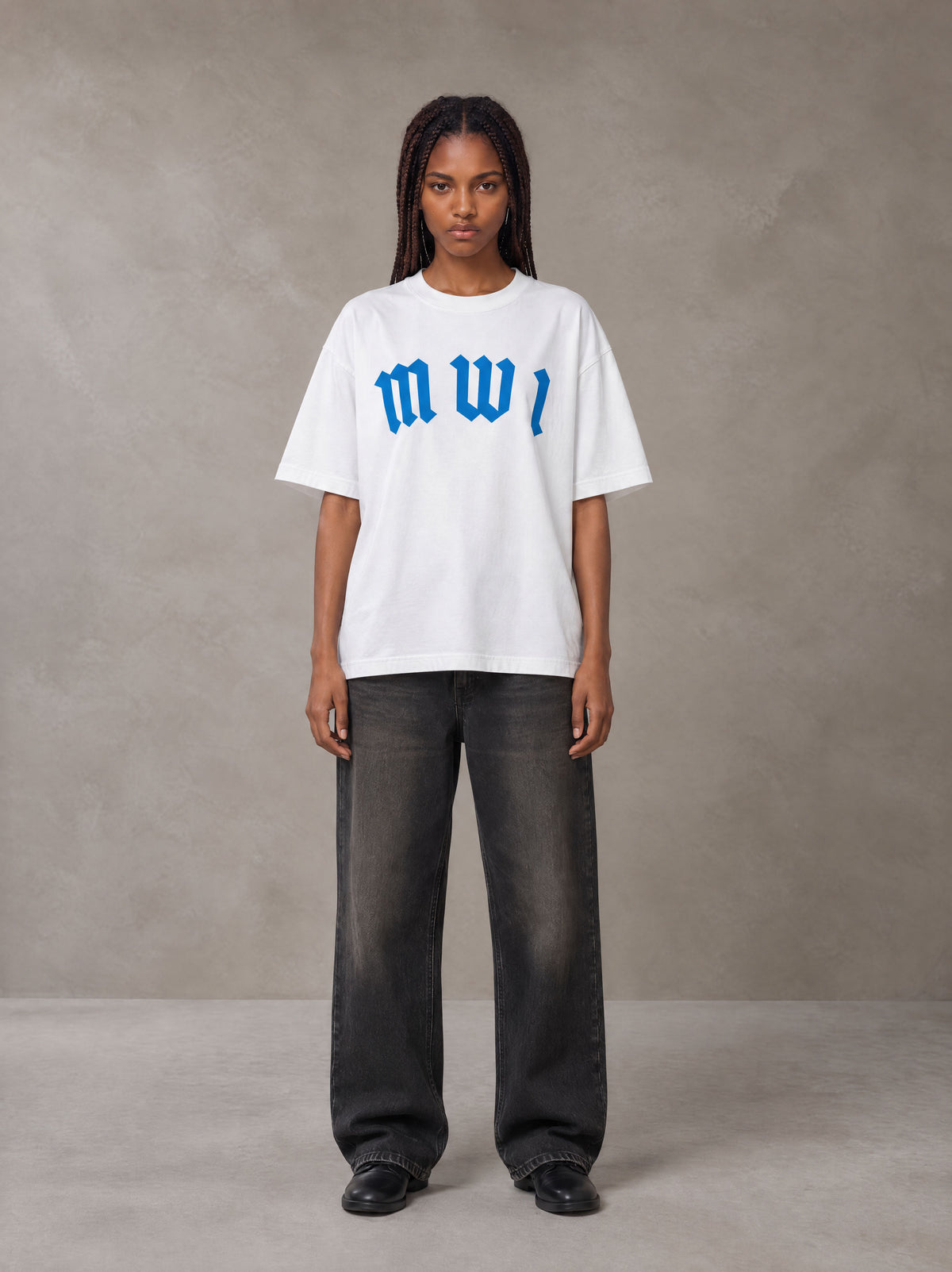 Model wearing the SM Script T-shirt in Lucent White, front view.