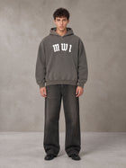 Model wearing the SM Script Washed Hoodie in Ashen Grey, front view.