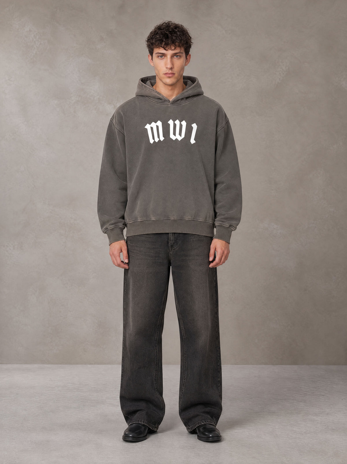 Model wearing the SM Script Washed Hoodie in Ashen Grey, front view.