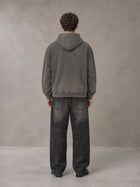 Model wearing the SM Script Washed Hoodie in Ashen Grey, rear view.