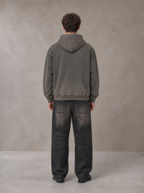 Model wearing the SM Script Washed Hoodie in Ashen Grey, rear view.