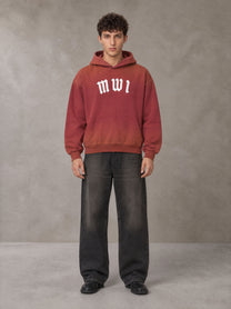 Model wearing the SM Script Washed Hoodie in Copper Rust, front view.