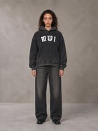 Model wearing the SM Script Washed Hoodie in Midnight Black, front view.