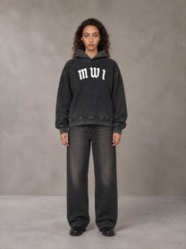 Model wearing the SM Script Washed Hoodie in Midnight Black, front view.