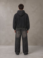 Model wearing the SM Script Washed Hoodie in Midnight Black, rear view.