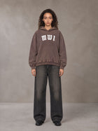 Model wearing the SM Script Washed Hoodie in Soft Taupe, front view.