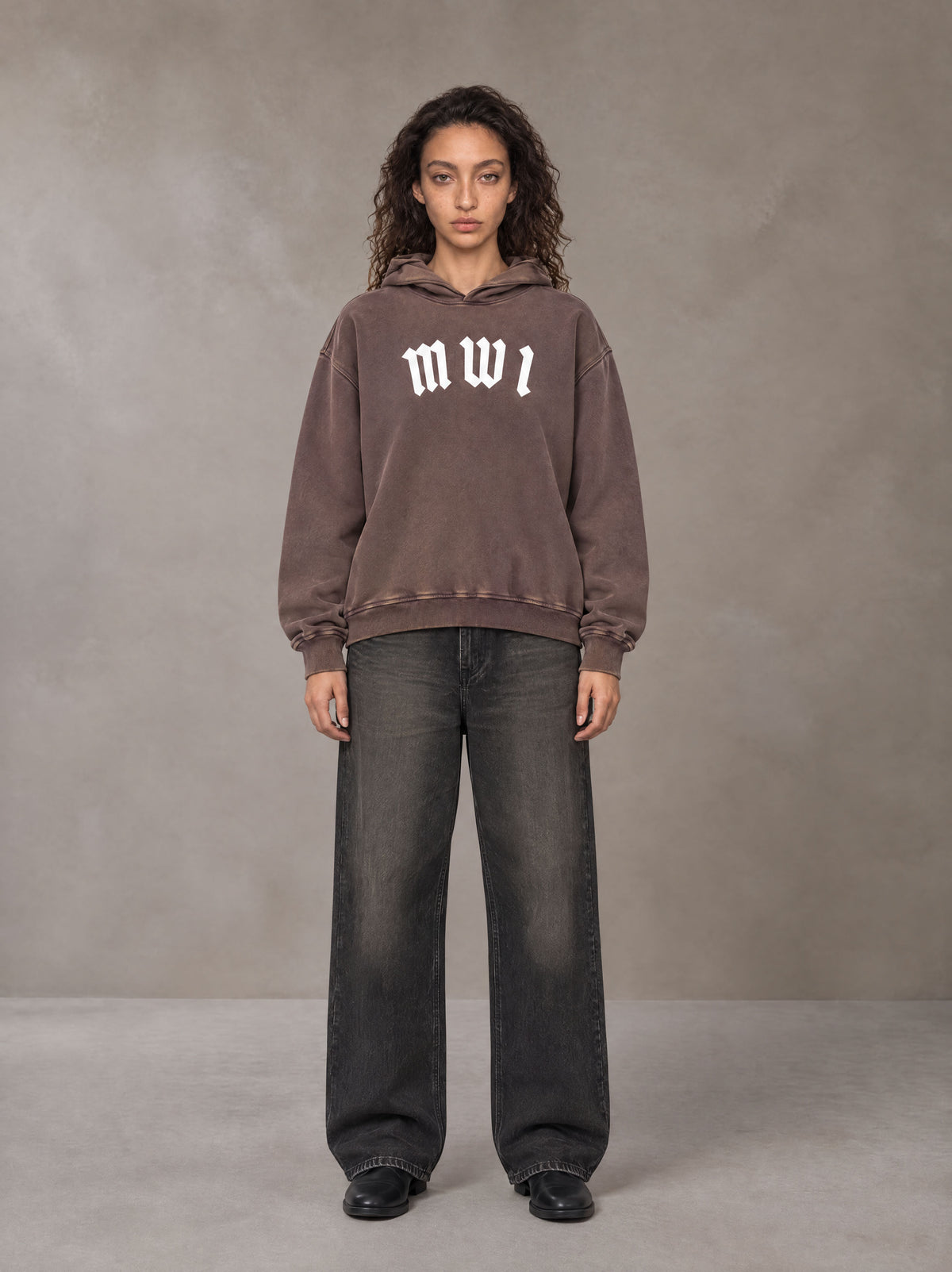 Model wearing the SM Script Washed Hoodie in Soft Taupe, front view.