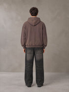 Model wearing the SM Script Washed Hoodie in Soft Taupe, rear view.
