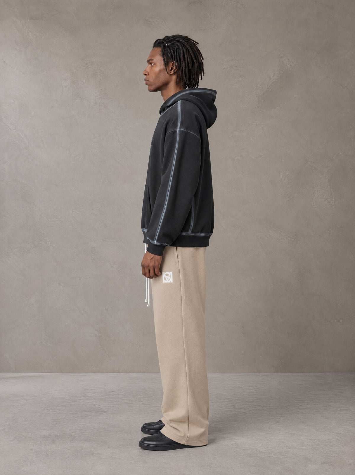 Model wearing the SM Fleece Straight Leg Trousers in Camel Tan, side profile.