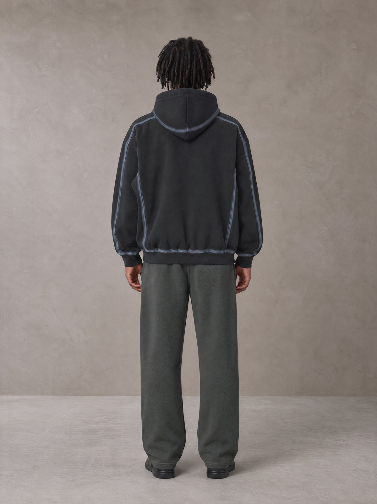 Model wearing the SM Fleece Straight Leg Trousers in Deep Charcoal, rear view.