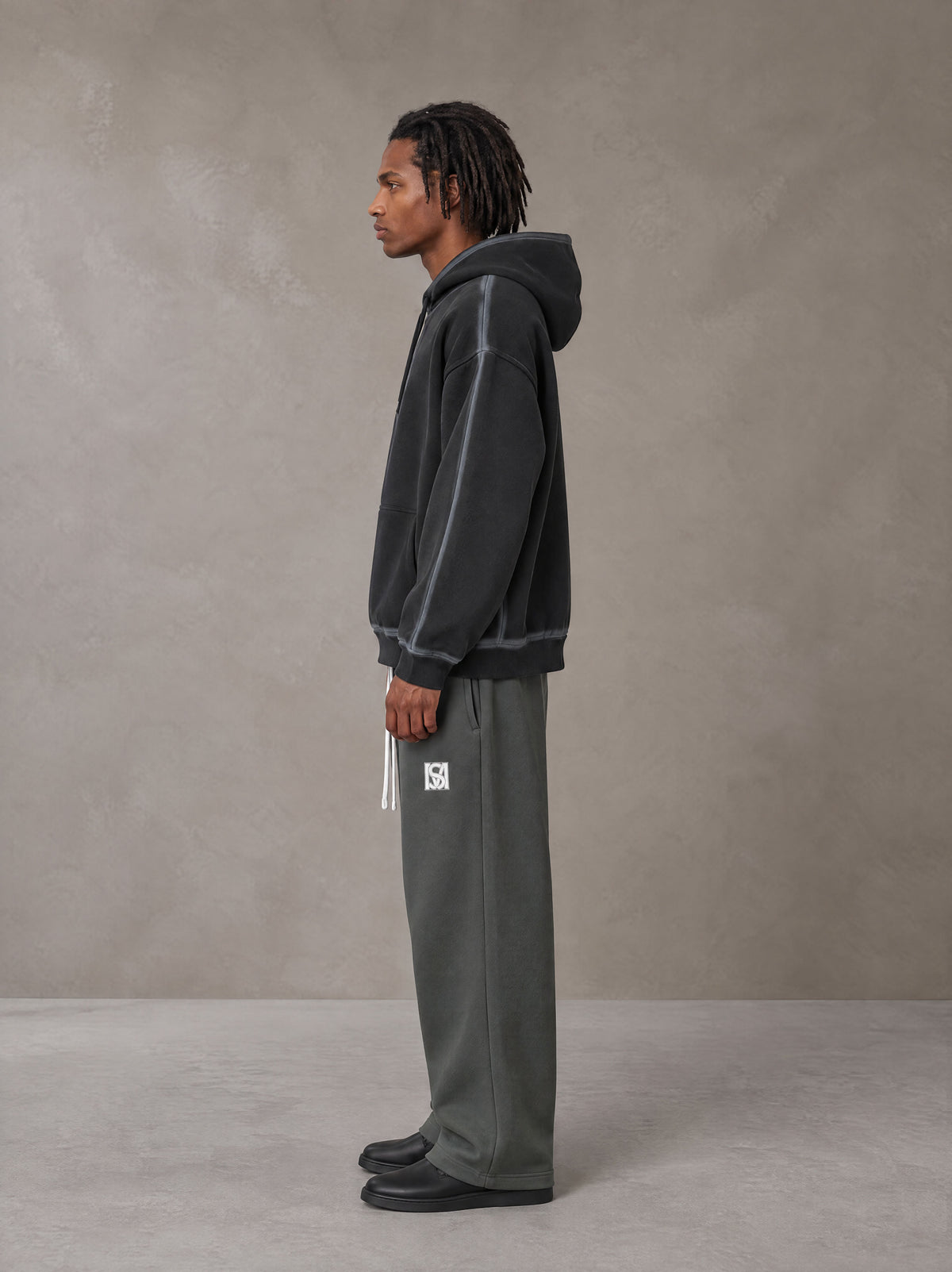 Model wearing the SM Fleece Straight Leg Trousers in Deep Charcoal, side profile.